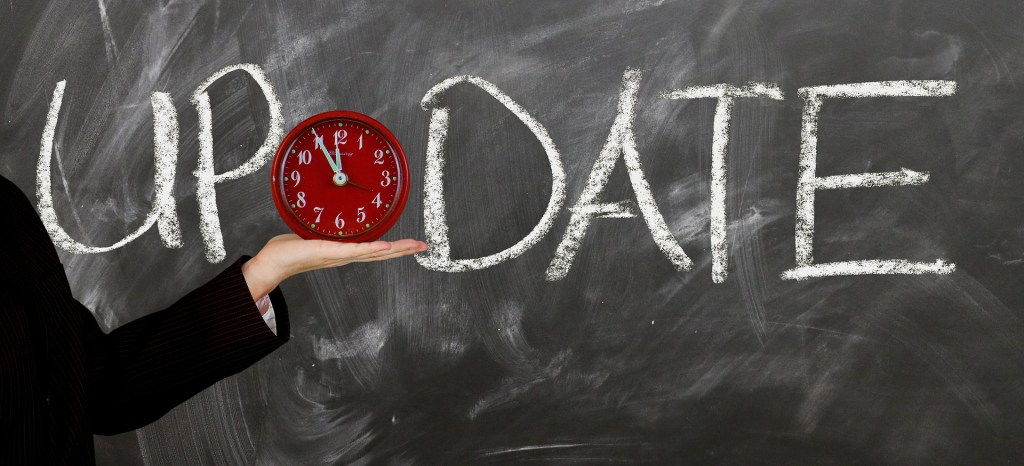 Word update on a chalkboard with a 12-hour clock over the letter 'A'.